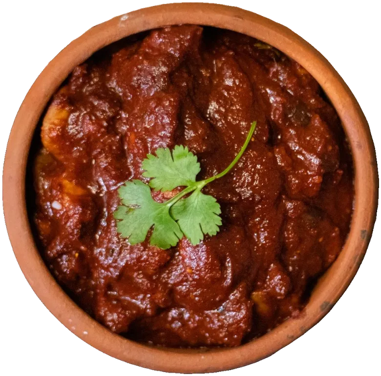 Dark pork curry in a clay bowl